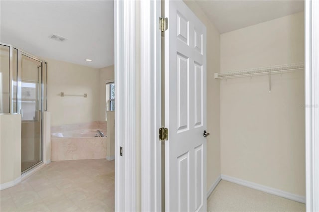 bathroom featuring baseboards, visible vents, a shower stall, and a bath