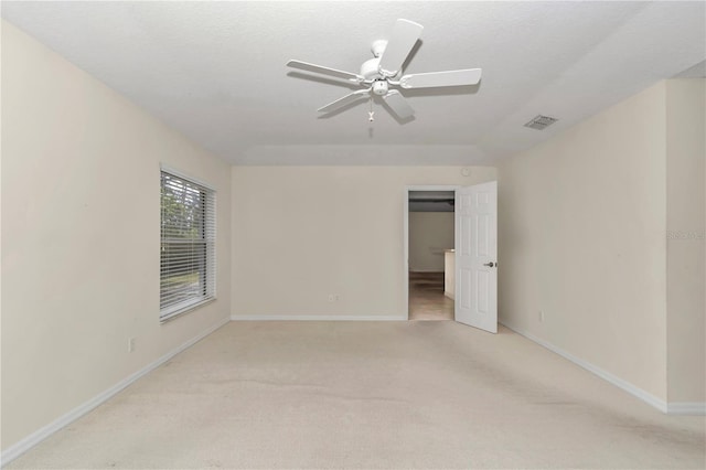 unfurnished bedroom featuring baseboards, light carpet, a ceiling fan, and visible vents