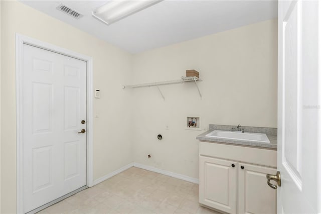 laundry room with washer hookup, visible vents, cabinet space, a sink, and baseboards