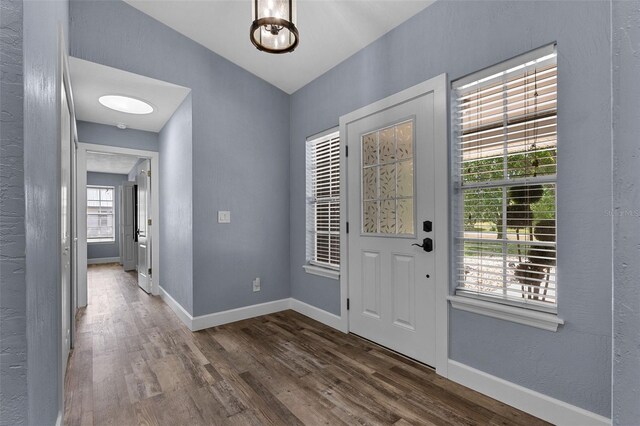 260 Country Circle Dr W, Port Orange, FL 32128 - entrance foyer featuring baseboards, lofted ceiling, and wood finished floors