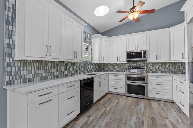 260 Country Circle Dr W, Port Orange, FL 32128 - kitchen with a ceiling fan, a sink, white cabinetry, vaulted ceiling, and stainless steel appliances