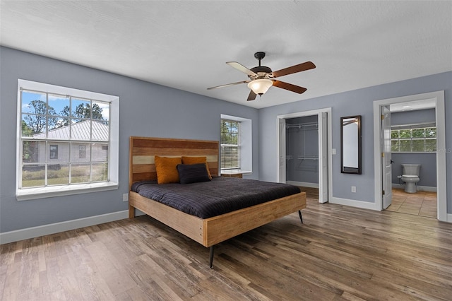 260 Country Circle Dr W, Port Orange, FL 32128 - bedroom featuring multiple windows, wood finished floors, a closet, and baseboards