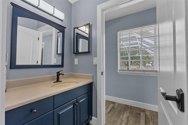 260 Country Circle Dr W, Port Orange, FL 32128 - bathroom with baseboards, vanity, and wood finished floors