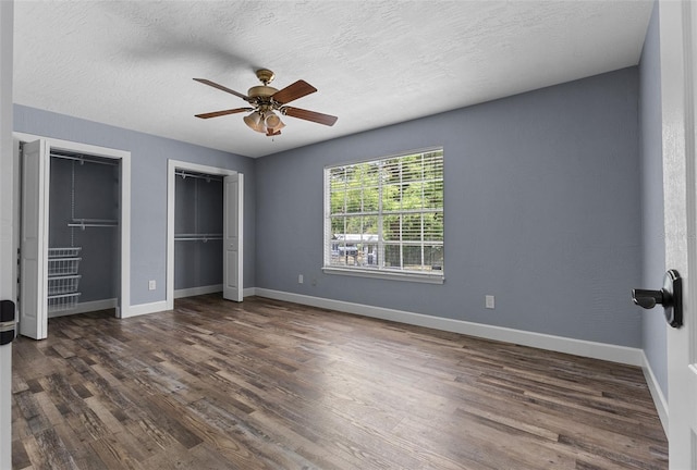 260 Country Circle Dr W, Port Orange, FL 32128 - unfurnished bedroom with baseboards, multiple closets, a ceiling fan, and wood finished floors
