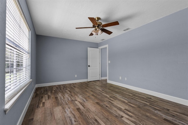 260 Country Circle Dr W, Port Orange, FL 32128 - empty room with dark wood-style flooring, baseboards, ceiling fan, and visible vents