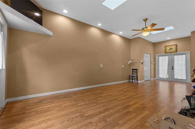 260 Country Circle Dr W, Port Orange, FL 32128 - unfurnished living room with a skylight, baseboards, light wood-type flooring, and a ceiling fan