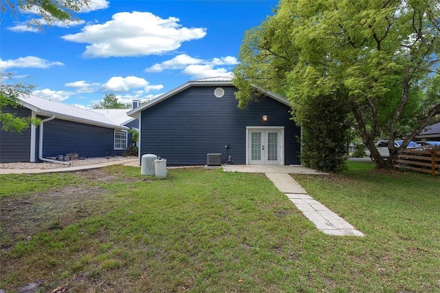 260 Country Circle Dr W, Port Orange, FL 32128 - rear view of house featuring a yard, french doors, metal roof, and central AC