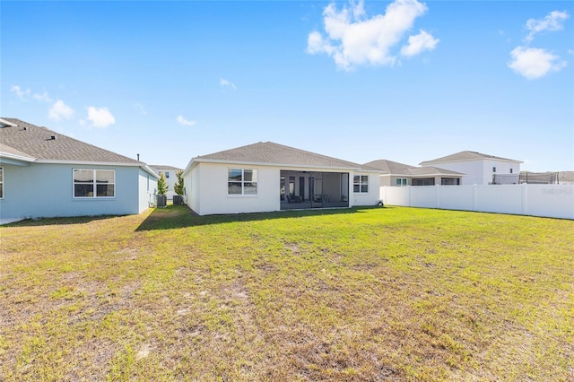 6342 SW 77th Ave, Ocala, FL 34474 - back of property with a yard, stucco siding, a sunroom, and fence