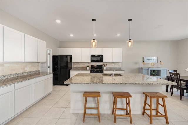 6342 SW 77th Ave, Ocala, FL 34474 - kitchen with backsplash, a kitchen breakfast bar, black appliances, and a sink