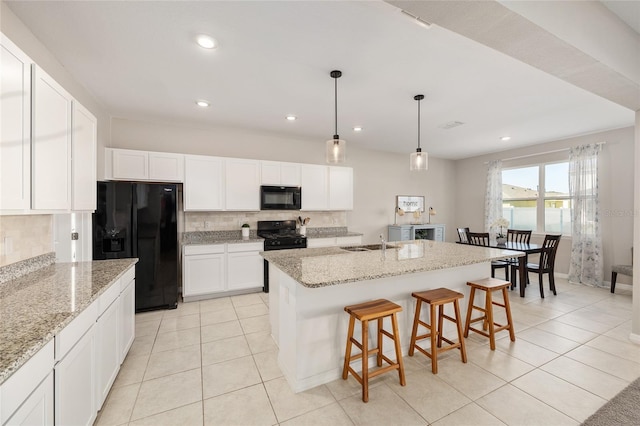 6342 SW 77th Ave, Ocala, FL 34474 - kitchen with backsplash, black appliances, light tile patterned floors, and white cabinetry