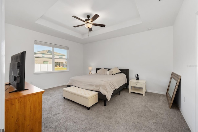 6342 SW 77th Ave, Ocala, FL 34474 - carpeted bedroom with a tray ceiling, baseboards, and a ceiling fan