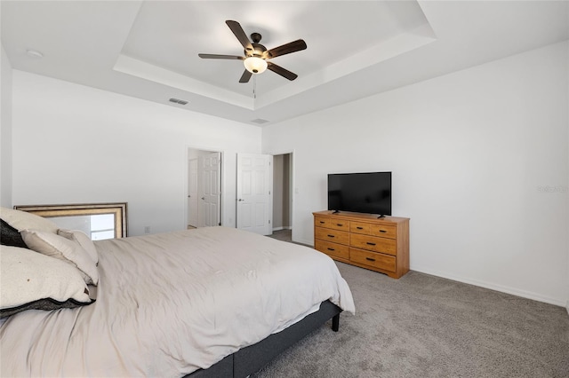6342 SW 77th Ave, Ocala, FL 34474 - bedroom featuring visible vents, ceiling fan, carpet floors, a tray ceiling, and baseboards