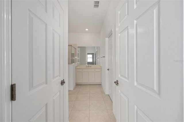 6342 SW 77th Ave, Ocala, FL 34474 - hall with recessed lighting, light tile patterned floors, visible vents, and a sink