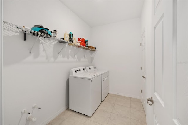 6342 SW 77th Ave, Ocala, FL 34474 - laundry area with washing machine and clothes dryer, baseboards, laundry area, and light tile patterned floors