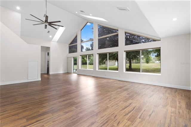 170 SW 80th St, Ocala, FL 34476 - unfurnished living room featuring high vaulted ceiling, ceiling fan, wood finished floors, baseboards, and a skylight