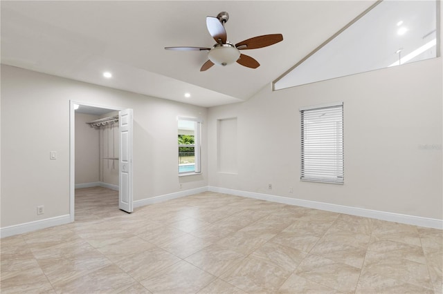 170 SW 80th St, Ocala, FL 34476 - unfurnished bedroom featuring a walk in closet, vaulted ceiling, recessed lighting, a ceiling fan, and baseboards