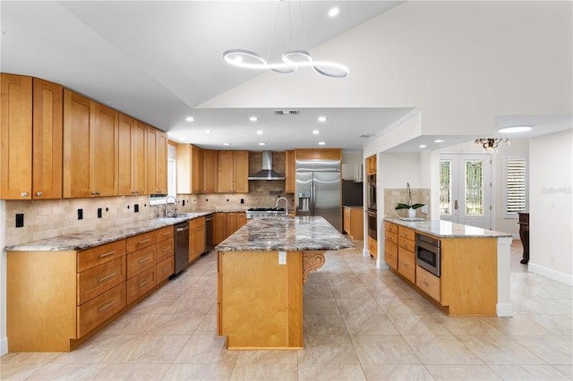 170 SW 80th St, Ocala, FL 34476 - kitchen with wall chimney exhaust hood, stainless steel appliances, a sink, a center island with sink, and tasteful backsplash