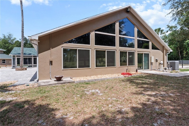 170 SW 80th St, Ocala, FL 34476 - back of property with a patio area, central AC unit, stucco siding, and a lawn