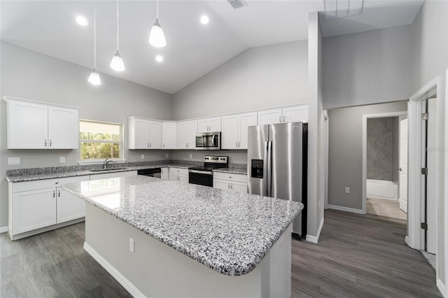 kitchen featuring stainless steel appliances, high vaulted ceiling, a kitchen island, white cabinets, and pendant lighting