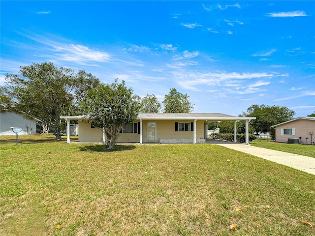 6263 SW 107th St, Ocala, FL 34476 - single story home with concrete driveway, cooling unit, an attached carport, and a front lawn