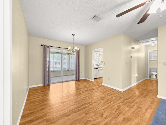6263 SW 107th St, Ocala, FL 34476 - interior space featuring a textured ceiling, baseboards, visible vents, ceiling fan with notable chandelier, and light wood-type flooring