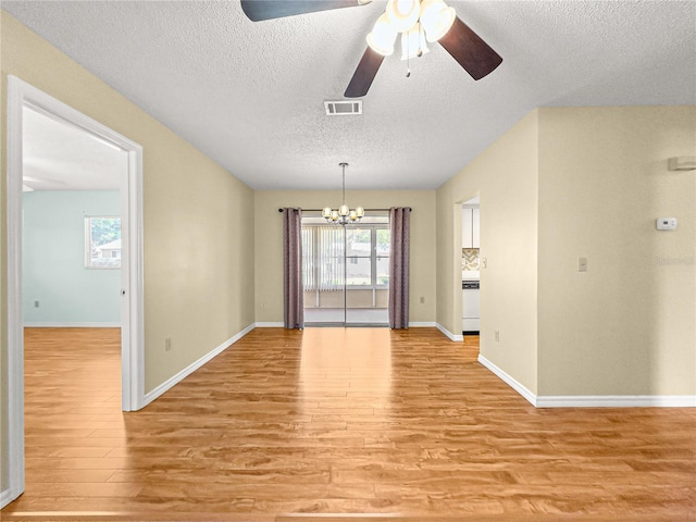 6263 SW 107th St, Ocala, FL 34476 - unfurnished dining area with light wood-style floors, visible vents, ceiling fan with notable chandelier, and a textured ceiling