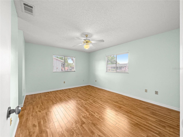 6263 SW 107th St, Ocala, FL 34476 - unfurnished room with plenty of natural light, a ceiling fan, visible vents, and wood finished floors