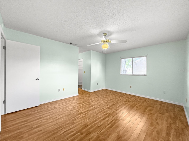 6263 SW 107th St, Ocala, FL 34476 - empty room featuring a textured ceiling, baseboards, ceiling fan, visible vents, and wood finished floors
