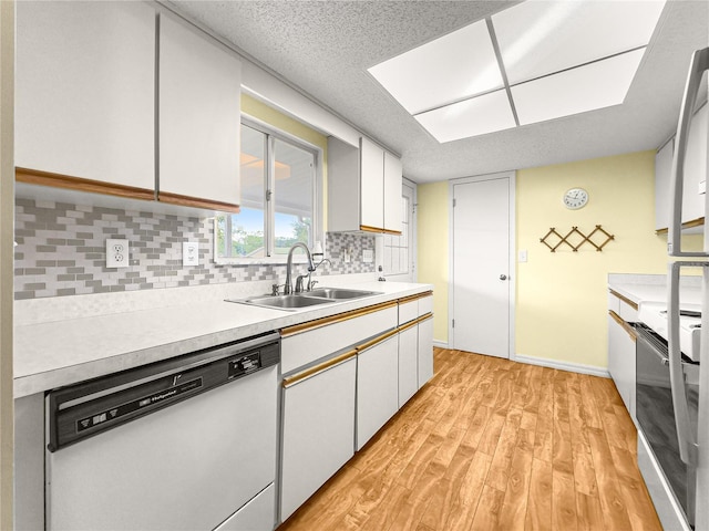 6263 SW 107th St, Ocala, FL 34476 - kitchen with light wood-style flooring, a sink, white appliances, light countertops, and tasteful backsplash