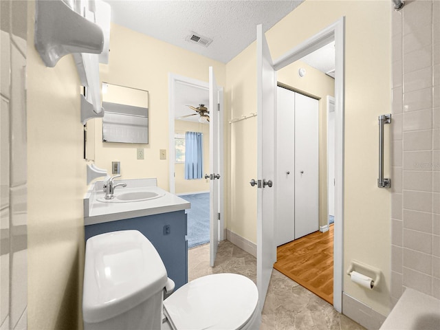 6263 SW 107th St, Ocala, FL 34476 - bathroom with a textured ceiling, toilet, ceiling fan, visible vents, and vanity