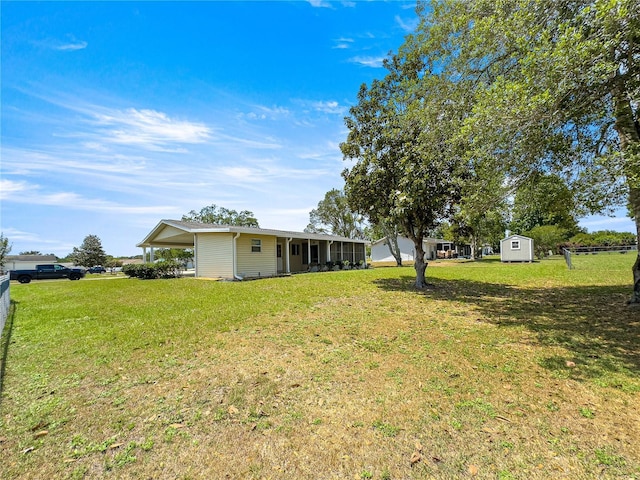 6263 SW 107th St, Ocala, FL 34476 - view of yard featuring an outdoor structure, fence, and a storage unit