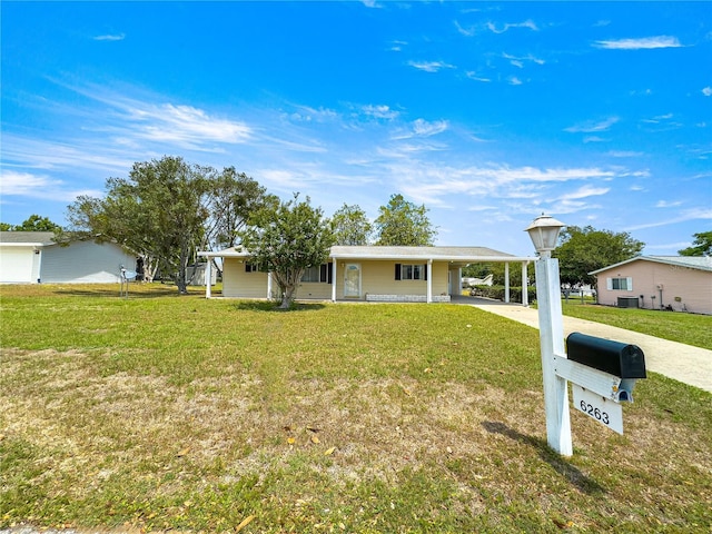 6263 SW 107th St, Ocala, FL 34476 - ranch-style house featuring concrete driveway, a front lawn, and a carport
