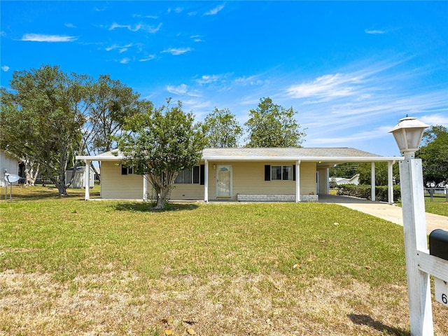 6263 SW 107th St, Ocala, FL 34476 - ranch-style house with concrete driveway, an attached carport, and a front lawn