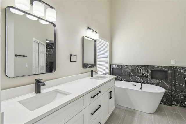 1317 Ravida Woods Dr, Apopka, FL 32703 - full bathroom with tile walls, a soaking tub, double vanity, and wainscoting