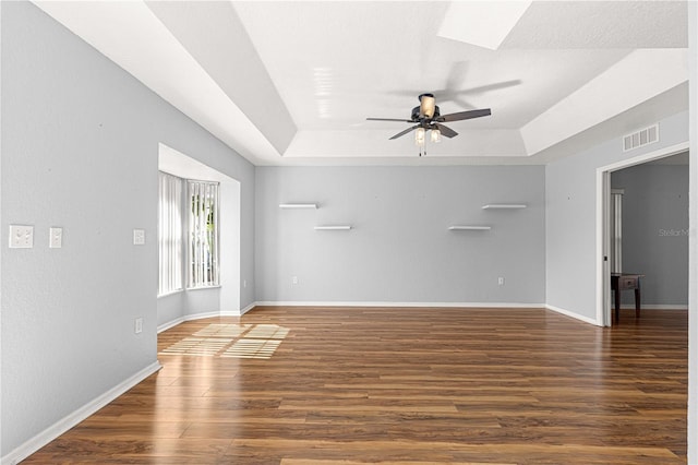 6758 SW 114th Street Rd, Ocala, FL 34476 - empty room with a tray ceiling, ceiling fan, wood finished floors, and baseboards
