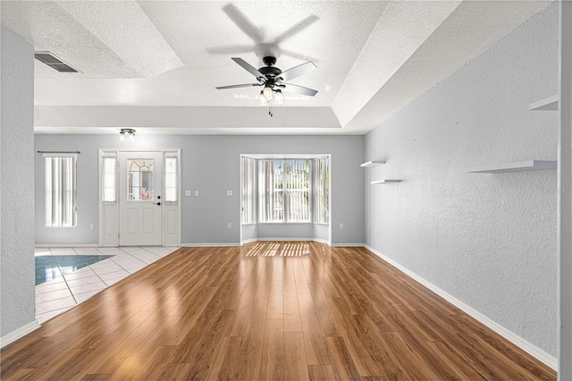 6758 SW 114th Street Rd, Ocala, FL 34476 - unfurnished living room featuring visible vents, a textured ceiling, and a textured wall