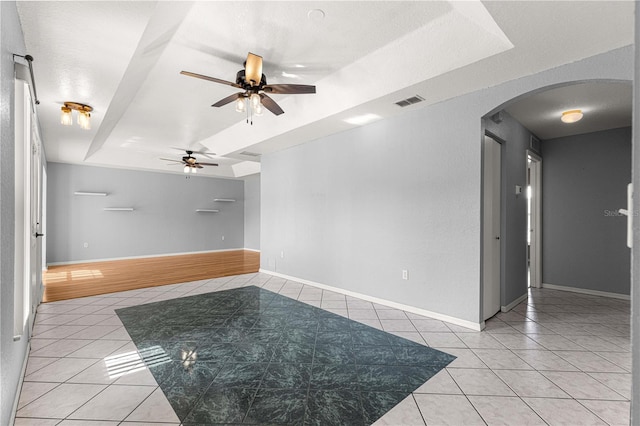 6758 SW 114th Street Rd, Ocala, FL 34476 - spare room with light tile patterned floors, visible vents, ceiling fan, and arched walkways