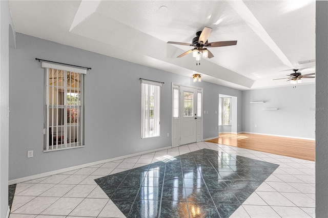6758 SW 114th Street Rd, Ocala, FL 34476 - tiled entrance foyer with a tray ceiling, baseboards, and ceiling fan