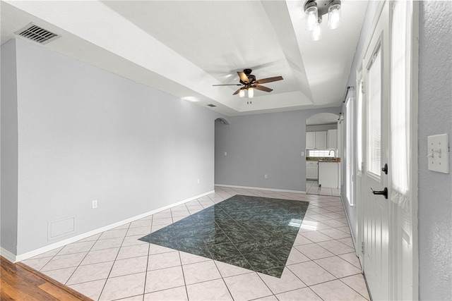6758 SW 114th Street Rd, Ocala, FL 34476 - interior space featuring light tile patterned floors, ceiling fan, visible vents, arched walkways, and a raised ceiling