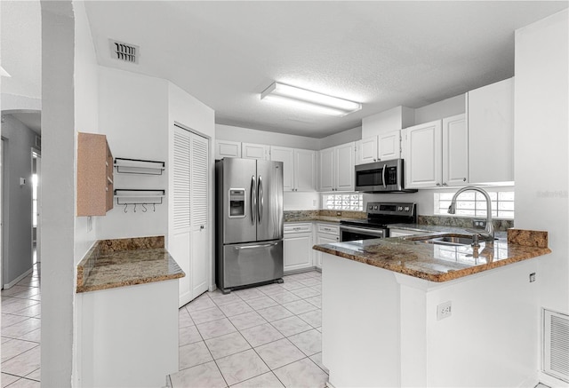 6758 SW 114th Street Rd, Ocala, FL 34476 - kitchen featuring a sink, a peninsula, light tile patterned flooring, and appliances with stainless steel finishes