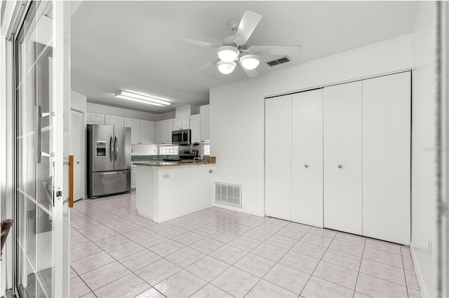 6758 SW 114th Street Rd, Ocala, FL 34476 - kitchen with a peninsula, appliances with stainless steel finishes, visible vents, and light tile patterned flooring