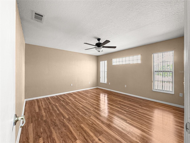 6758 SW 114th Street Rd, Ocala, FL 34476 - unfurnished room with a ceiling fan, visible vents, a textured ceiling, and wood finished floors