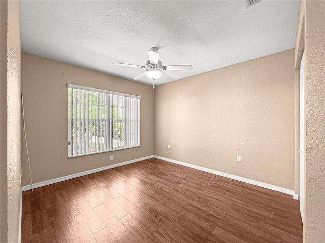 6758 SW 114th Street Rd, Ocala, FL 34476 - empty room with ceiling fan, a textured ceiling, baseboards, and wood finished floors