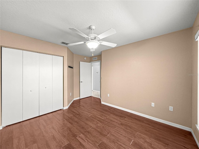 6758 SW 114th Street Rd, Ocala, FL 34476 - unfurnished bedroom featuring a closet, wood finished floors, a textured ceiling, visible vents, and baseboards