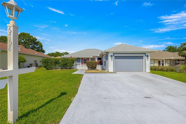 6758 SW 114th Street Rd, Ocala, FL 34476 - ranch-style house featuring an attached garage, central AC, stucco siding, a front lawn, and driveway