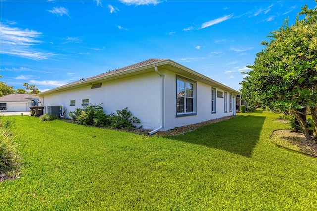 6758 SW 114th Street Rd, Ocala, FL 34476 - view of property exterior with central AC unit, stucco siding, and a lawn