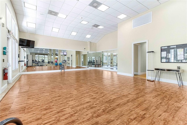 6758 SW 114th Street Rd, Ocala, FL 34476 - workout area featuring a towering ceiling, wood finished floors, and baseboards