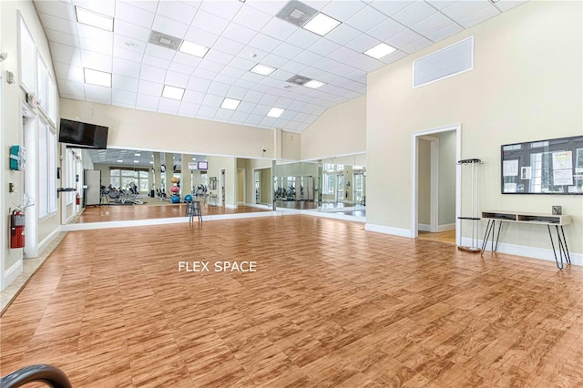 6758 SW 114th Street Rd, Ocala, FL 34476 - workout area featuring a high ceiling, wood finished floors, and baseboards