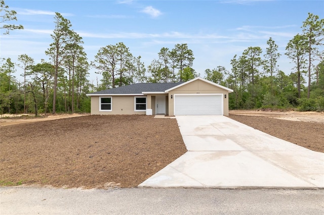 23131 SW Rainelle Rd, Dunnellon, FL 34431 - ranch-style house with an attached garage, concrete driveway, and stucco siding