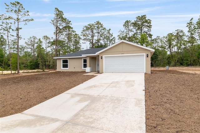 23131 SW Rainelle Rd, Dunnellon, FL 34431 - ranch-style house featuring driveway, a garage, and stucco siding